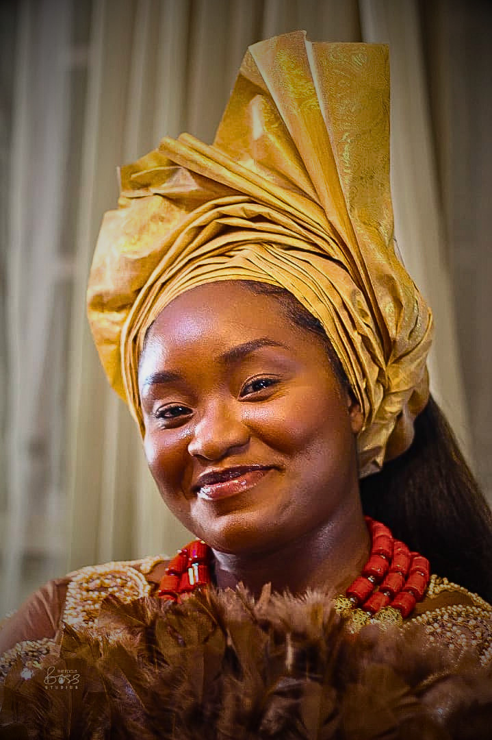 A radiant bride in traditional gold attire and coral beads